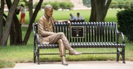 Sculpture of Dr. Thomas Starzel sitting on a bench by the Cathedral of Learning